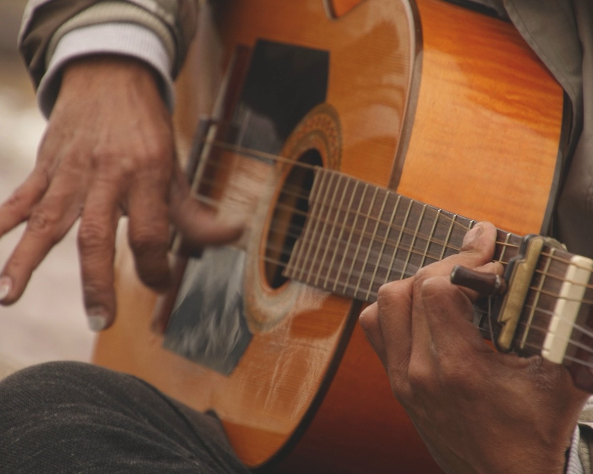 Close-up of a flamenco guitarist's hands playing a Spanish guitar