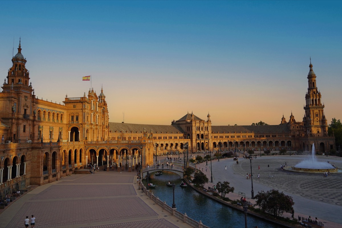 Plaza de España in Seville at golden hour with its canal and towers